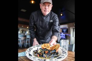 Whidbey Island chef Michael Weeks welcomes visitors to Penn Cove Musselfest, returning to Whidbey Island, Washington, March 7 to 9. Photo by Luisa Loi