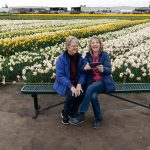 Lauri Ledbeter, right, sits with Genie Hallman at Roozengaarde outside of Mount Vernon, Washington during the Skagit Valley Tulip Festival on April 10, 2025. (Will Geschke / The Herald)
