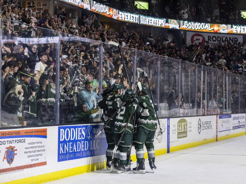 Everett Silvertips players celebrate teammate Landon DuPont scoring during game seven of the second round of the WHL playoffs against the Portland Winterhawks on Tuesday, April 22, 2025 in Everett, Washington. (Olivia Vanni / The Herald)