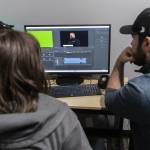 Emmalee Brazier watches as Chris Gove shows how to drag audio to start syncing at The Teen Storytellers Project on Tuesday, April 29, 2025 in Everett, Washington. (Olivia Vanni / The Herald)