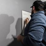 Chris Gove writes project naming instructions on a whiteboard at The Teen Storytellers Project on Tuesday, April 29, 2025 in Everett, Washington. (Olivia Vanni / The Herald)