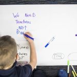 Kids write down their thoughts of the proposed closing of the Early Learning Center on Tuesday, Nov. 30, 2021 in Everett, Wa. (Olivia Vanni / The Herald)