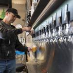 Cole Rinehardt pours a beer for a customer on Wednesday, March 12, 2025 in Arlington, Washington. (Olivia Vanni / The Herald)