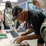 Brian Murril, who started at Liberty Elementary as a kindergartner in 1963, looks for his yearbook photograph during an open house for the public to walk through the school before its closing on Thursday, May 29, 2025 in Marysville, Washington. (Olivia Vanni / The Herald)