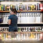 Bar manager Faith Britton pours a beer for a customer at the Madison Avenue Pub in Everett. (Olivia Vanni / The Herald)