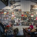 Band photos cover a wall inside the Madison Avenue Pub. (Olivia Vanni / The Herald)