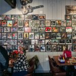 Band photos cover a wall inside the Madison Avenue Pub on Tuesday, Dec. 17, 2024 in Everett, Washington. (Olivia Vanni / The Herald)