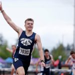 Arlington’s Parker Duskin throws up a hand after defeating the competition in the 3A boys 300 hurdles Saturday, May 28, 2022, at the 2022 WIAA State Track & Field Championships at Mount Tahoma High School in Tacoma, Washington. (Ryan Berry / The Herald)