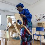 Fatou Drammeh-Darboe, who has taught at the Early Learning Center for 17 years, stacks up chairs in her classroom on the last day of school on Wednesday, June 25, 2025 in Everett, Washington. (Olivia Vanni / The Herald)