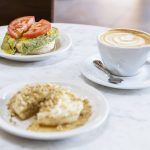 Rob’s Favorite crumpet with green egg, English cheese, tomato on smoked salmon cream cheese and The Walrus crumpet with walnuts and ricotta honey on Tuesday, June 24, 2025 in Edmonds, Washington. (Olivia Vanni / The Herald)