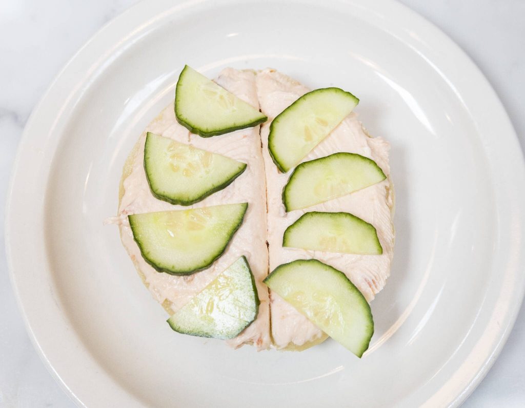 Cucumbers cover smoked salmon cream cheese on a crumpet on Tuesday, June 24, 2025 in Edmonds, Washington. (Olivia Vanni / The Herald)