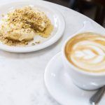 The Walrus crumpet with walnuts, ricotta and honey and a latte on Tuesday, June 24, 2025 in Edmonds, Washington. (Olivia Vanni / The Herald)