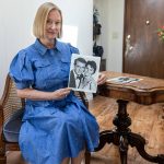 Annzolee Olsen with her chair, from Houseboat, and card table from a Robert Redford movie on Wednesday, July 23, 2025 in Everett, Washington. (Olivia Vanni / The Herald)