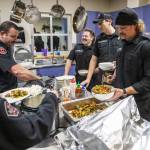 Firefighters at Everett Fire Station One dish up the dinner for 12 they prepared themselves. The fire crews rotate kitchen duty during their monthly shifts. Breaking to answer an emergency call is par for the course. (Olivia Vanni / The Herald)
Firefighters at Everett Fire Station One dish up the dinner for 12 they prepared themselves. The fire crews rotate kitchen duty during their monthly shifts. Breaking to answer an emergency call is par for the course. (Olivia Vanni / The Herald)