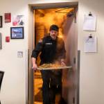 Ryan Fromm walks into the Everett fire station with a steaming tray of chicken and vegetables for dinner. (Olivia Vanni / The Herald)
Ryan Fromm walks into the Everett fire station with a steaming tray of chicken and vegetables for dinner. (Olivia Vanni / The Herald)