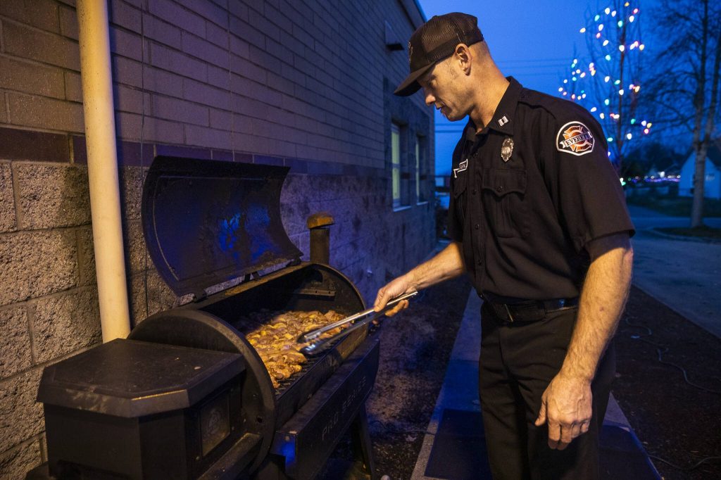 Todd Stark grills up chicken for Everett Fire Station Ones dinner. (Olivia Vanni / The Herald)
Todd Stark grills up chicken for Everett Fire Station Ones dinner. (Olivia Vanni / The Herald)