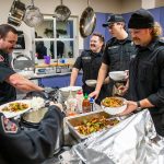 Fire Station One firefighters fill their bowls and plates with dinner on Tuesday, Dec. 10, 2024 in Everett, Washington. (Olivia Vanni / The Herald)