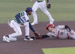 Everett AquaSox infielder Felnin Celesten tags Spokane’s Cole Messina as he slide into second base during the game on Wednesday, Aug. 20, 2025 in Everett, Washington. (Olivia Vanni / The Herald)