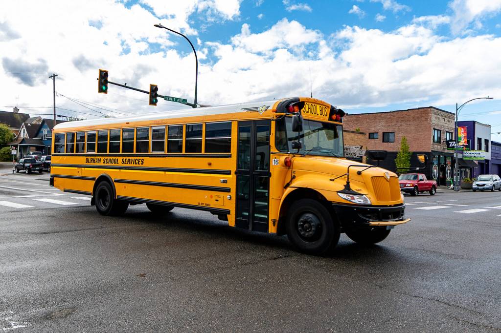 An Everett school bus crosses Hewitt Avenue as it travels north on Cedar Street on Wednesday in Everett. (Aaron Kennedy / The Herald)