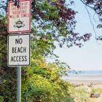 "No Beach Access" and “By Order of the Sheriff” tow-away signs installed at Hillman Place a public right-of-way near Soundview Drive Northwest in Stanwood. (K’allen Specht)