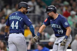 The Seattle Mariners' Cal Raleigh (29) is congratulated by Julio Rodriguez (44) after hitting a two-run home run against the San Diego Padres during the sixth inning at Petco Park on May 16, 2025, in San Diego. (Orlando Ramirez / Getty Images / Tribune News Services)