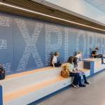 People sit on benches in the main hallway of Explorer Middle Schools new athletics building on Oct. 7, 2025 in Everett, Washington. (Olivia Vanni / The Herald)