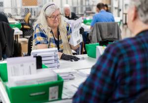 Jenita Vogt opens ballots with acceptable signatures to be scanned in the Snohomish County Election Center on Nov. 3, 2025 in Everett, Washington. (Olivia Vanni / The Herald)