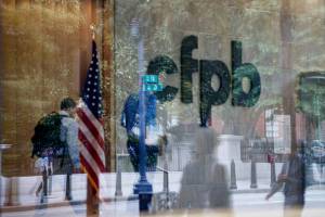 FILE — The Consumer Financial Protection Bureau logo is seen through a window at the CFPB offices in Washington on Sept. 23, 2019. Employees of the Consumer Financial Protection Bureau were instructed to cease “all supervision and examination activity” and “all stakeholder engagement,” effectively stopping the agency’s operations, in an email from the director of the Office of Management and Budget, Russell Vought, on Saturday, Feb. 8, 2025. (Ting Shen/The New York Times)