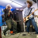 JJ Sobchuk, 14, left, and Owen Barton, 14, jump while doing a run through a set list during a group lesson at the Music Circle on Dec. 1, 2025 in Everett, Washington. (Olivia Vanni / The Herald)