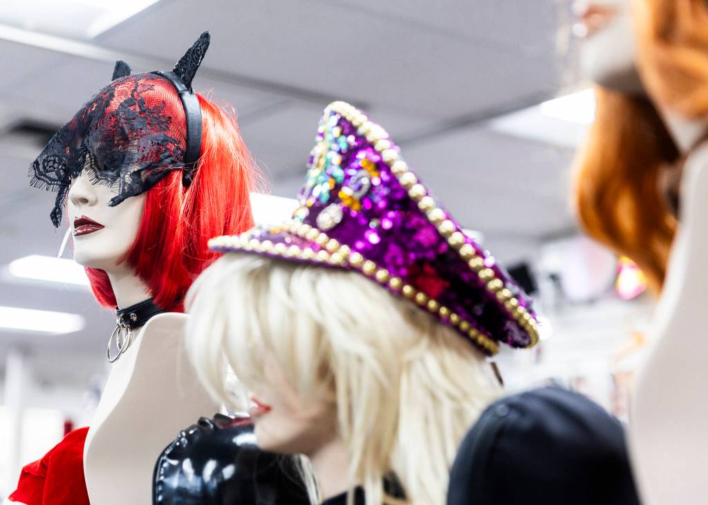 Wigs, chokers, hats and other accessories on display at Lovers Lair on Dec. 19, 2025 in Everett. (Olivia Vanni / The Herald)