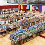 Stacks of food line the gymnasium in Cascade High School during its annual food drive event on Wednesday, Dec. 17 in Everett, Washington. (Will Geschke / The Herald)