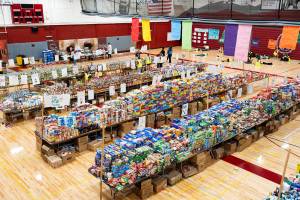 Stacks of food line the gymnasium in Cascade High School during its annual food drive event on Wednesday, Dec. 17 in Everett, Washington. (Will Geschke / The Herald)