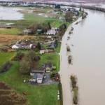 The Snohomish River begins to spill over Rivershore Road and into the field to the east on Thursday, Dec. 11, 2025 in Snohomish, Washington. (Olivia Vanni / The Herald)