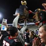 Archbishop Murphys Tayden Olson holds up the 2A state championship trophy to the Archbishop Murphy student section at Husky Stadium on Saturday, Dec. 6, 2025, in Seattle, Washington. (Olivia Vanni / The Herald)