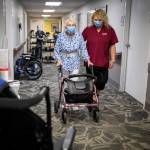 Certified Nursing Assistant Nina Prigodich assists with restorative exercises with long-term care patient Betty Long, 86, at View Ridge Care Center in February, 2023, in Everett. (Olivia Vanni / The Herald file photo)