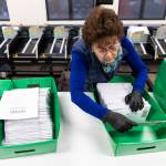 Election worker Tina Ruybal prepares ballot envelopes to be moved to the extraction point in the Snohomish County Election Center on Nov. 3, 2025 in Everett. (Olivia Vanni / The Herald file photo)