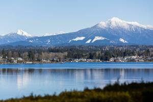 The peaks of Mount Pilchuck, left, and Liberty Mountain, right, are covered in snow on Wednesday, Feb. 12, 2025 in Lake Stevens, Washington. (Olivia Vanni / The Herald)