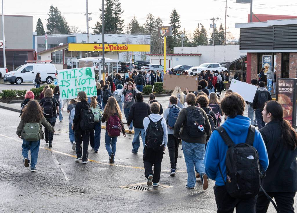 Students from Everett High School walk onto Broadway Avenue during a walkout from the high school in protest of ICE on Tuesday, Jan. 13, 2026, in Everett, Washington. (Will Geschke / The Herald)