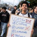 Tyree Elegan, a sophomore at Everett High School, holds a sign and walks along 25th Street during a walkout at the school in protest of ICE on Tuesday, Jan. 13, 2026, in Everett, Washington. (Will Geschke / The Herald)