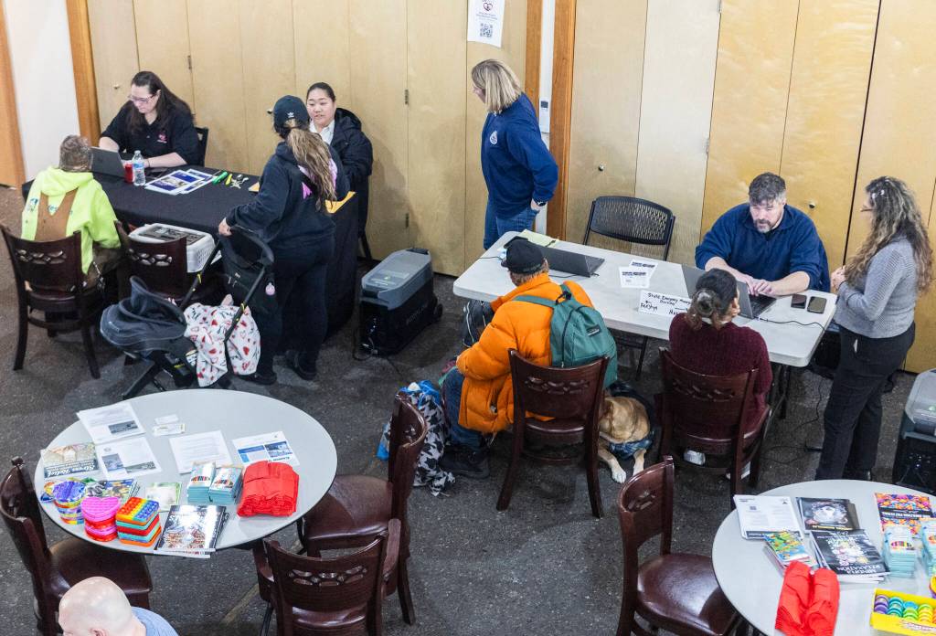 People receive assistance at the Disaster Assistance Center set up at the Volunteers of America Sky Valley Center on Wednesday, Jan. 14, 2026 in Sultan, Washington. (Olivia Vanni / The Herald)