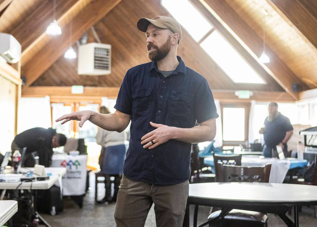 Tyler Verda talks before the Disaster Assistance Center opens on Wednesday, Jan. 14, 2026 in Sultan, Washington. (Olivia Vanni / The Herald)
