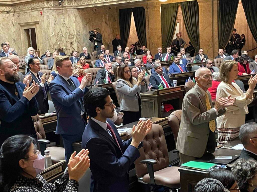 Democrats stand and clap, as Republicans remain in their chairs during Gov. Bob Fergusons State of the State address on Jan. 13, 2026. (Photo by Jerry Cornfield/Washington State Standard)