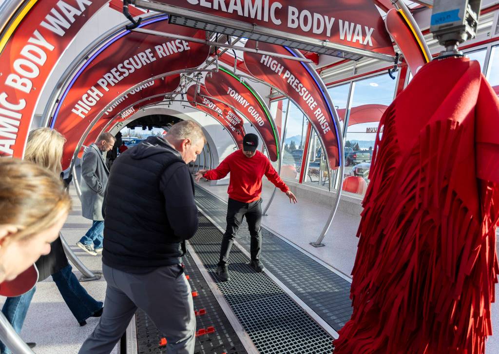 Phuong Truong shows where water drains inside Tommys Express Car Wash on Friday, Jan. 16, 2026 in Everett, Washington. (Olivia Vanni / The Herald)