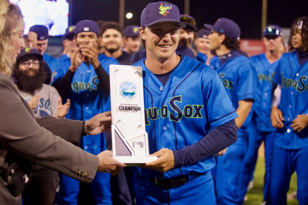 AquaSox manager Zach Vincej, who will not manage in 2026, is presented the Northwest League Championship trophy following Everetts series-clinching 6-3 win in Game 4 against the Eugene Emeralds at Funko Field on Sept. 13, 2025. (Joe Pohoryles / The Herald)