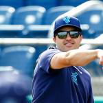 Everett AquaSox manager Ryan Scott plays catch behind the batting cage during practice Tuesday, April 2, 2024, at Funko Field in Everett, Washington. (Ryan Berry / The Herald)