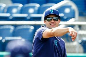 Everett AquaSox manager Ryan Scott plays catch behind the batting cage during practice Tuesday, April 2, 2024, at Funko Field in Everett, Washington. (Ryan Berry / The Herald)