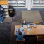 People read newspapers from a selection of publications at the Everett Public Library in April 2025 in Everett. (Olivia Vanni / The Herald file photo)