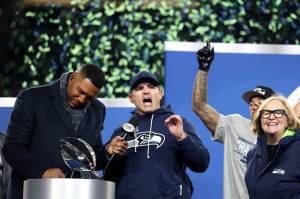 Seattle Seahawks head coach Mike MacDonald, middle, speaks before accepting the George Halas Trophy after defeating the Los Angeles Rams, 31-27, in the NFC Championship game at Lumen Field on Jan. 25, 2026, in Seattle. (Steph Chambers/Getty Images/TNS)