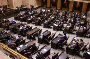 Washington state lawmakers in the House chamber on the first day of the 2026 legislative session. (Photo by Jacquelyn Jimenez Romero/Washington State Standard)