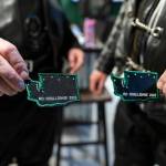 Two members show off their ride patches they earned on March 12, 2026, in Everett. (Olivia Vanni / The Herald)